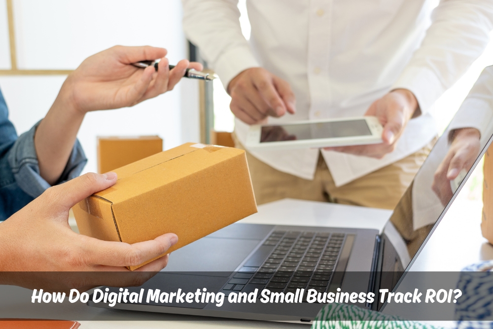A group of people holding a box and a laptop, representing Digital Marketing and Small Business.