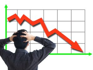 Man concerned over declining performance graph, indicating need for enterprise SEO marketing.