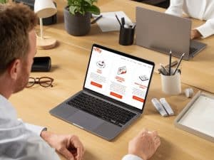 Businessman viewing Nifty Marketing’s seo reseller pricing page on a laptop in a modern Australian office workspace.