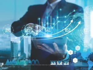 Business professional using a tablet with digital graphs and analytics showing growth percentages, illustrating a digital marketing solution in action.