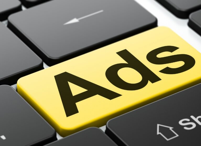 Ads key highlighted on a computer keyboard representing digital advertising and online marketing