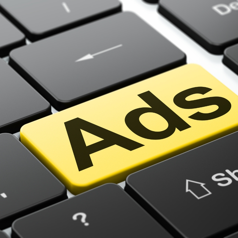 Ads key highlighted on a computer keyboard representing digital advertising and online marketing