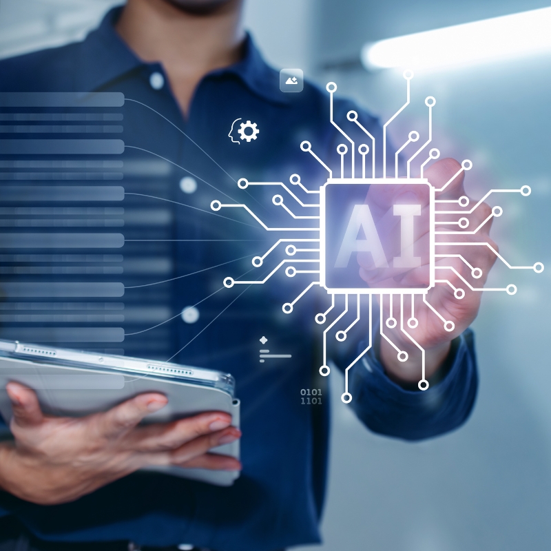 professional holding a tablet while interacting with a glowing AI chip graphic representing data processes and AEO systems.