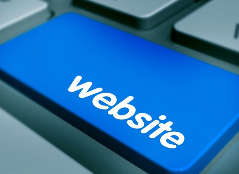 Close-up of a blue keyboard button with the text "website" to improve user experience and AEO performance.