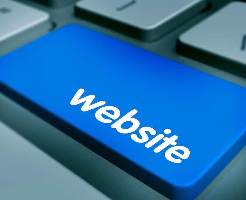 Close-up of a blue keyboard button with the text "website" to improve user experience and AEO performance.