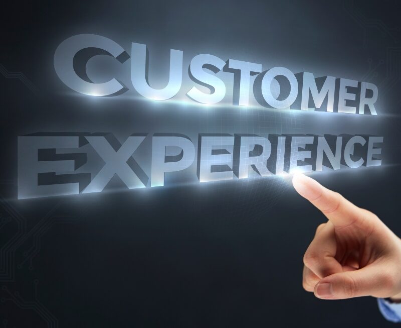 A finger pointing at glowing 3D text reading "CUSTOMER EXPERIENCE" to highlight AI Automation solutions.